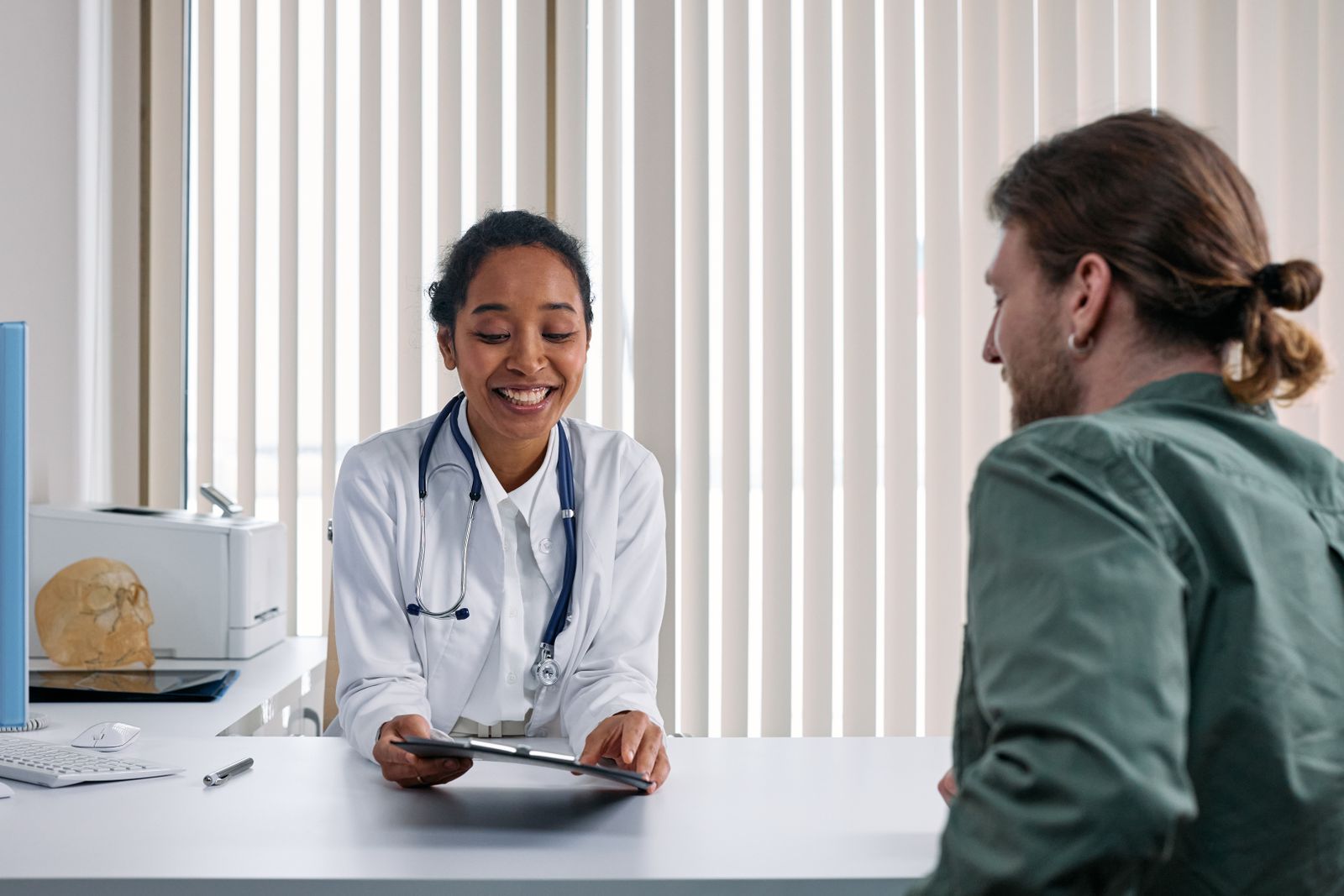 A clinician listening to a patient during a consultation